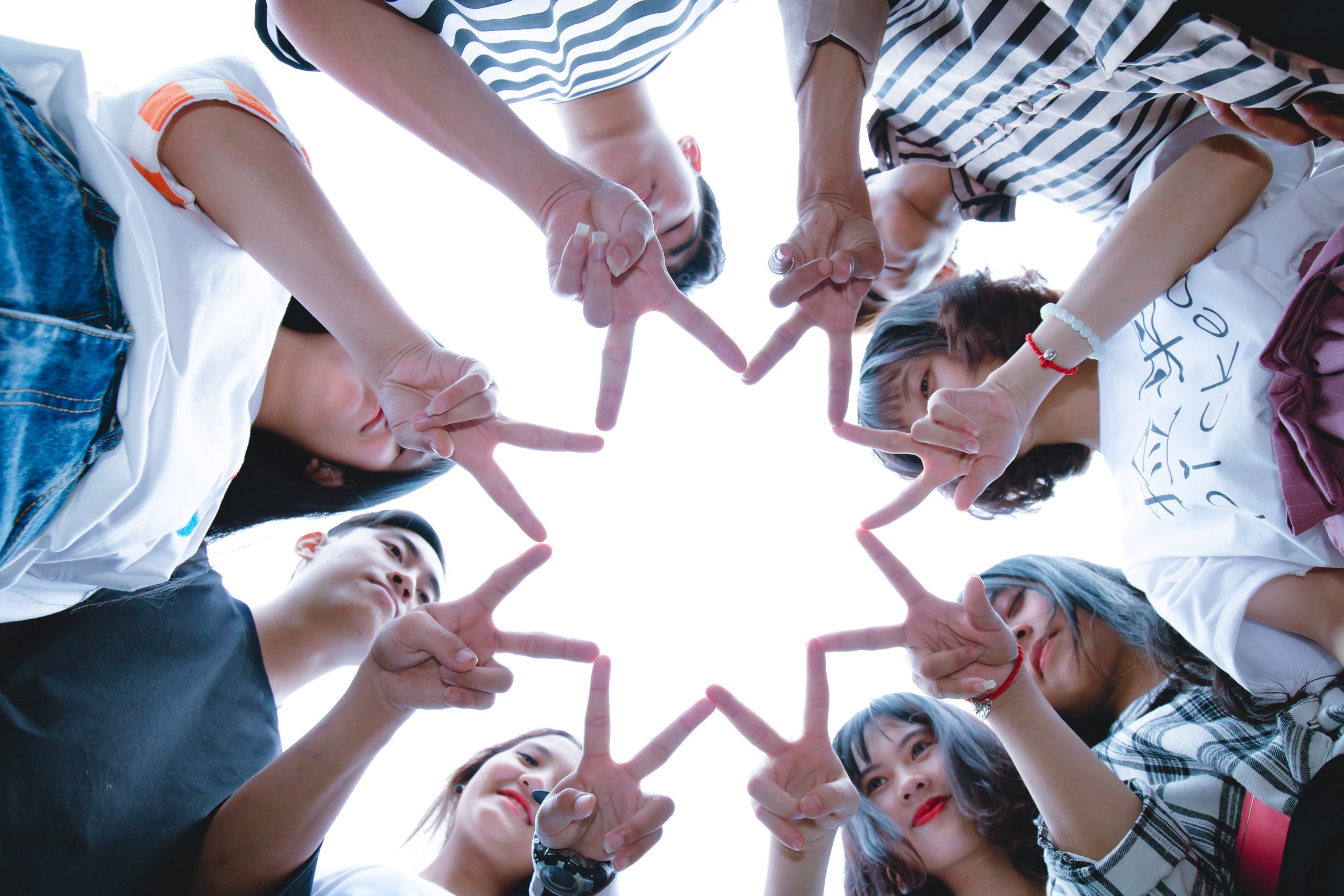 group-of-people-forming-star-using-their-hands-1116302-scaled.jpg