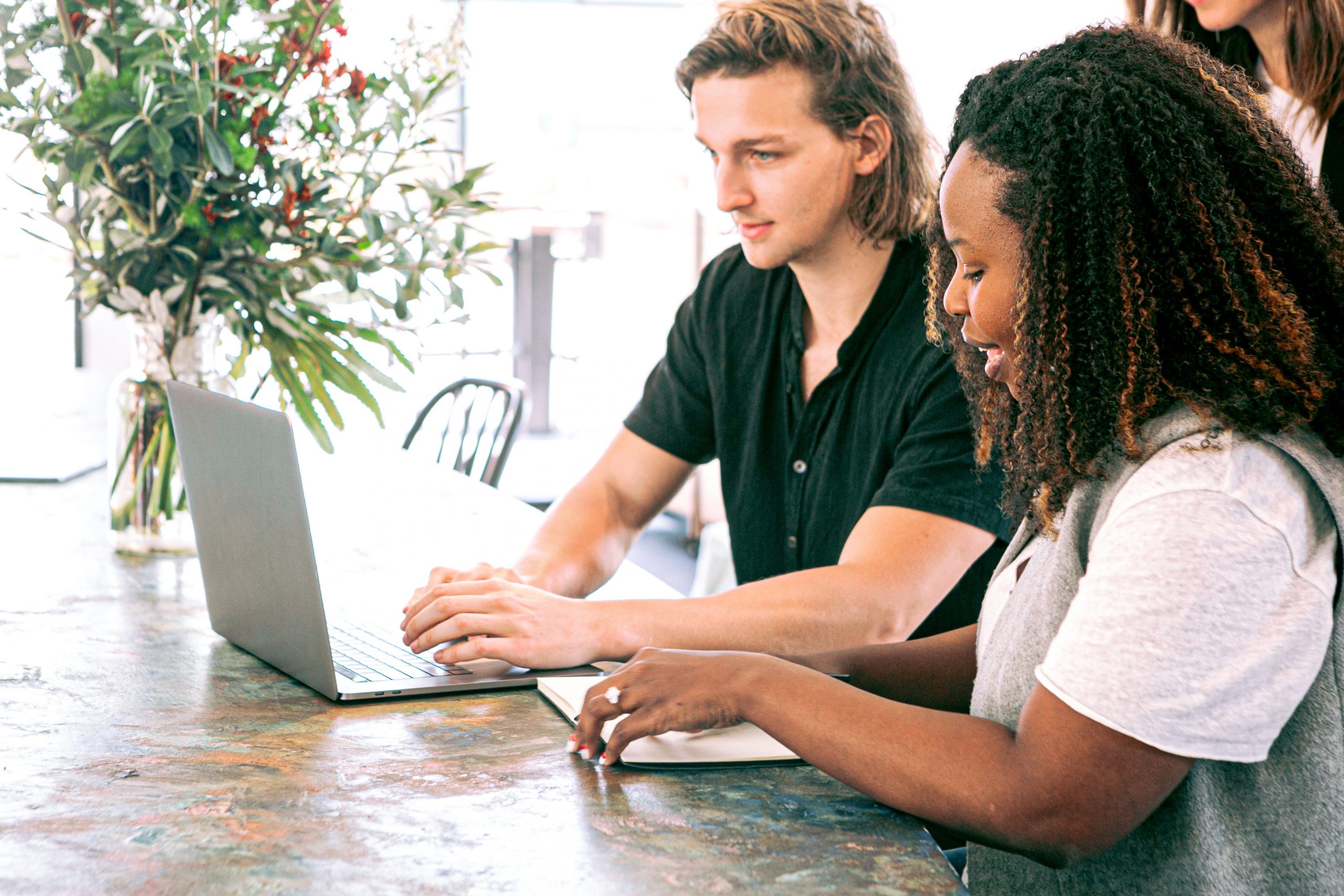 man-working-on-a-laptop-while-woman-takes-notes-3153208-scaled.jpg